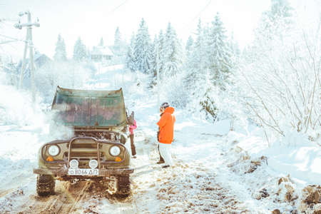 A man riding a snowboard down a snow covered slopeの写真素材