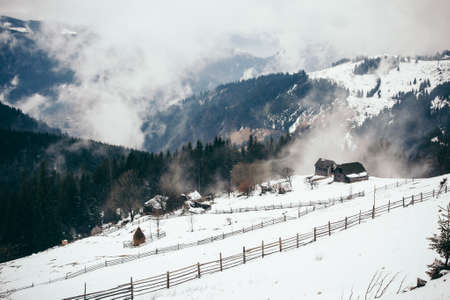 A group of people standing on top of a snow covered mountainの写真素材