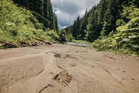 A group of people walking down a dirt roadの写真素材