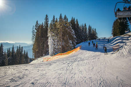 A man riding a snowboard down a snow covered slope
