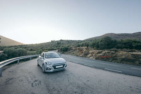 A car parked on the side of a roadの写真素材