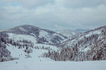 A man standing on top of a snow covered mountainの写真素材