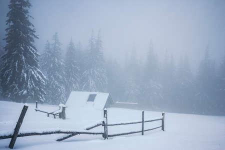 A sign on the side of a snow covered slopeの写真素材