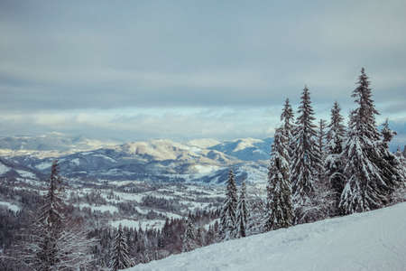 A man riding a snowboard down a snow covered slopeの写真素材
