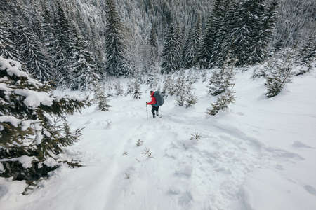 A man riding skis down a snow covered slopeの写真素材