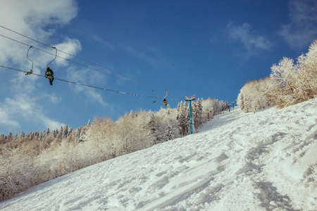 A person riding skis down a snow covered slopeの写真素材
