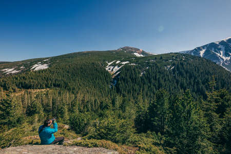 A man standing in front of a mountainの写真素材
