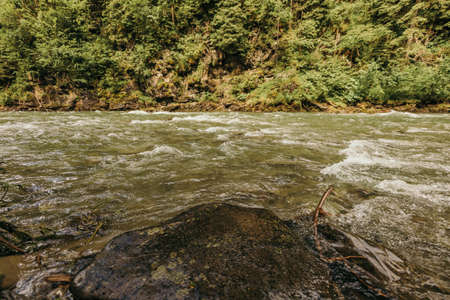 A rocky shore next to a body of waterの写真素材
