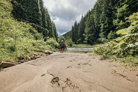 A man riding a bike down a dirt roadの写真素材