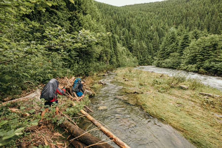 A man standing next to a riverの写真素材