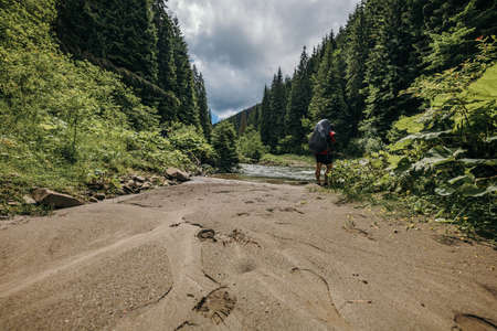 A man riding a bike down a dirt roadの写真素材