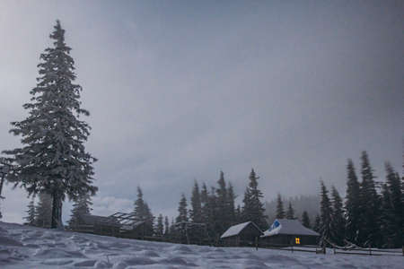 A person riding a snowboard down a snow covered slope