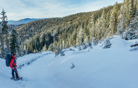 A man riding skis down a snow covered slopeの写真素材