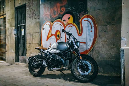 A motorcycle parked on the side of a buildingの写真素材