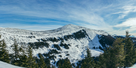 A man standing on top of a snow covered mountainの写真素材