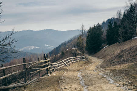 A train is on the side of a dirt fieldの写真素材