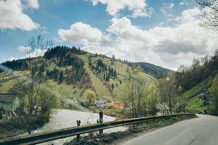 A large long train on a train track with trees in the backgroundの写真素材