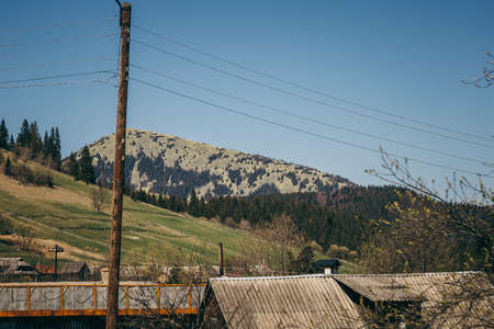 Stone mountain, spruce forest and electric poleの写真素材