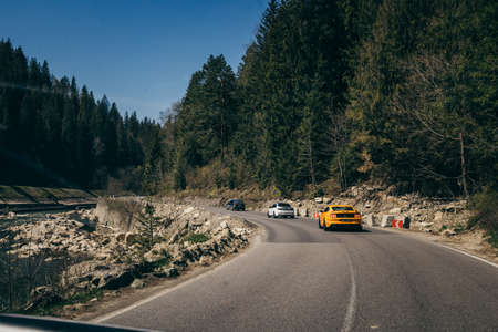 Road in the mountains near the river cars
