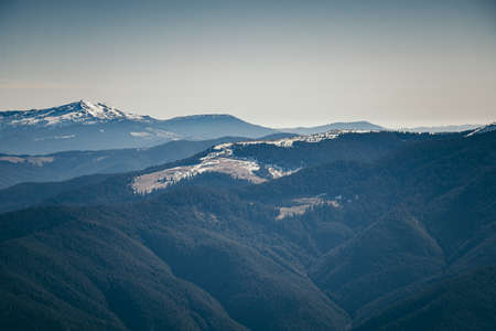 Mountains, coniferous forest in the snow, spring, winterの写真素材