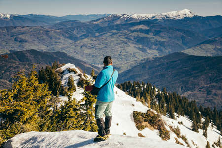 Mountains, coniferous forest in the snow, spring, winter, touristの写真素材
