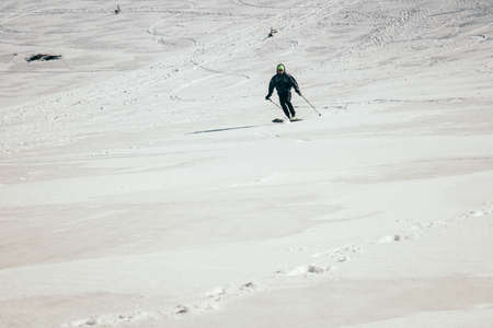 Snow in the mountains, skiers spring and winterの写真素材