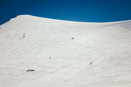 Snow in the mountains, skiers spring and winterの写真素材
