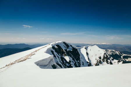 Snow in the mountains and blue sky, springの写真素材