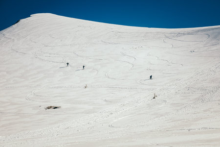 Snow in the mountains, skiers spring and winterの写真素材