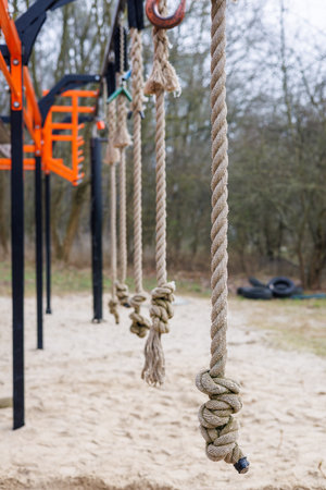 A close-up of a gymnastic rope hanging on a sports ground. The background is unfocused. High quality...
