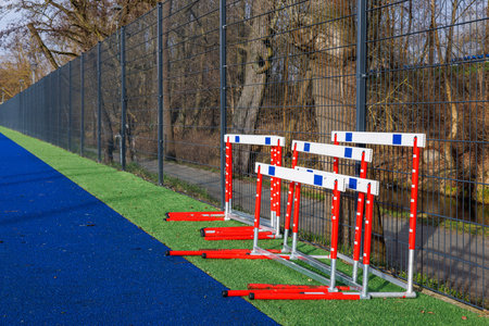 Athletics hurdles near the stadium running tracks. Red and white hurdles at the stadium. High...