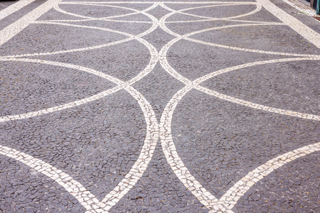 Typical Portuguese pavement with cobblestone patterns, hand-paved in Portugal, Madeira Island....