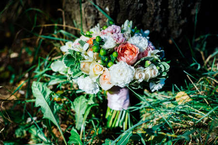 Lush wedding bouquet under the treeの写真素材