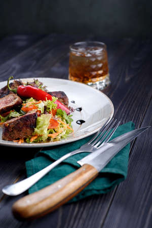 Tagliata of beef with salad on a white plateの写真素材