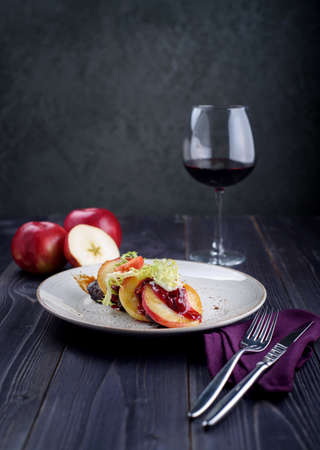 Goose liver with cherry sauce and apples and a glass of wineの写真素材