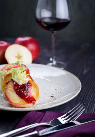 Goose liver with cherry sauce and apples and a glass of wineの写真素材