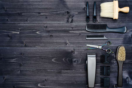 Hairdresser tools on wooden background. Top view on wooden table with scissors, comb, hairbrushes and hairclips, free space. Barbershopの写真素材