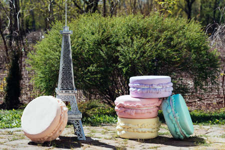 Big colorful artificial french macaroon. Wedding decoration in French style outdoorsの写真素材
