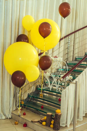 Yellow and brown balloons near the stairs. Wedding Decorationsの写真素材