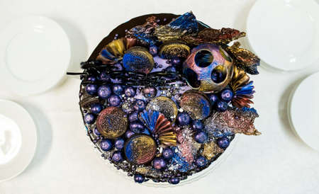 Top view of blue wedding cake with blueberries, biscuits, chocolate glaze  の写真素材