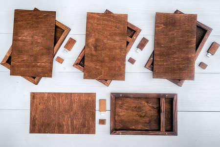 Empty wooden boxes for gift or photos with usb stick, free space. Packaging for photo and USB drives on white wooden background. Information and mail conceptの写真素材