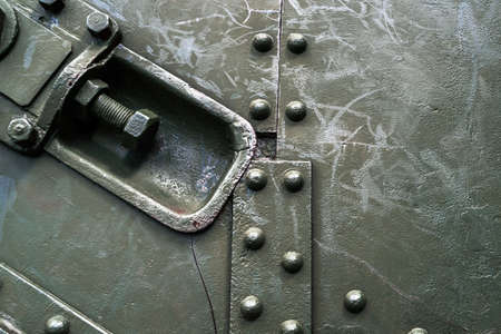 Abstract green industrial metal background texture with bolts and rivets. Old painted metal background, detail of military aircraft, surface corrosion, metal texture with rivetsの写真素材