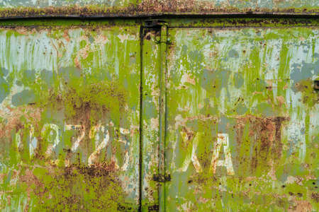 Rusty old green painted texture background. Green grunge metallic background. Metal texture with scratches and cracks, free spaceの写真素材