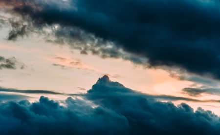 Dramatic gray, blue and orange sunset on beautiful sky, free space. Sky background on sunset with cloudsの写真素材