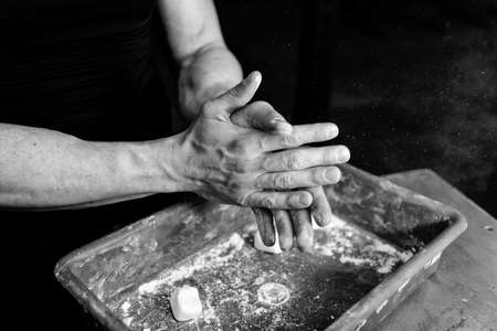 Man athlete coating his hands in powder chalk magnesium. Ready for workout training. Magnesium of gymnasticの写真素材