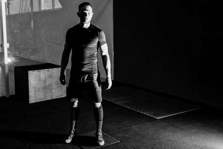 Young bearded man in gym after training. Full body length portraitの写真素材