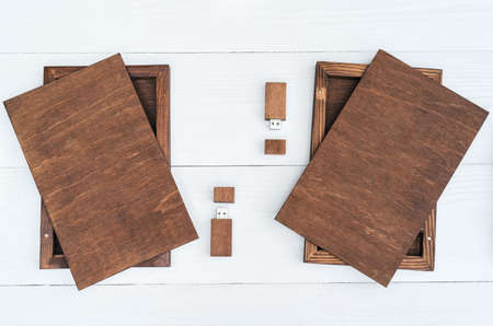 Empty blank wooden boxes for gift or photos with usb stick, free space. Packaging for photo and USB drives on white wooden background. Information and mail conceptの写真素材
