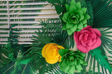 Beautiful artificial paper flowers and leaves background, free space. Floral background, copy space, view from above. Holiday greeting card for Valentine's Day, Woman's Day (March 8), Mother's Dayの写真素材