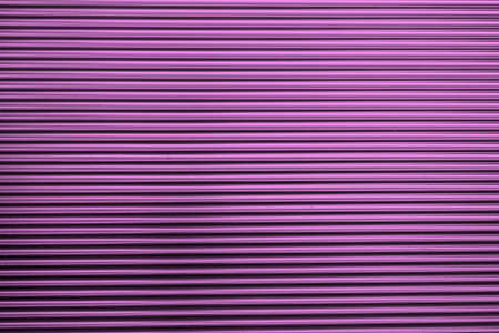 Metal corrugated background with free space for text. Purple wavy grooved metal texture, copy spaceの写真素材