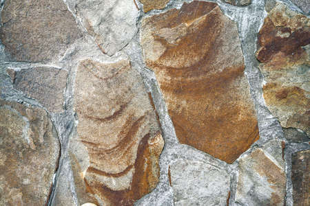 Brown stone background texture, free space. Stone tile floor paving fragment. Stone wall surface with cementの写真素材